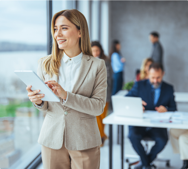 Woman standing in an office smiling